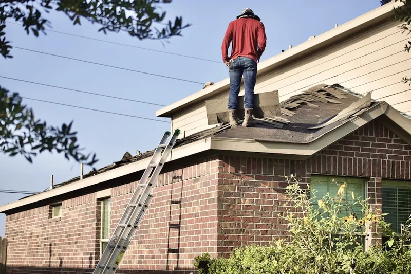 Professional roofer working on a residential roof in Whitehall Corners